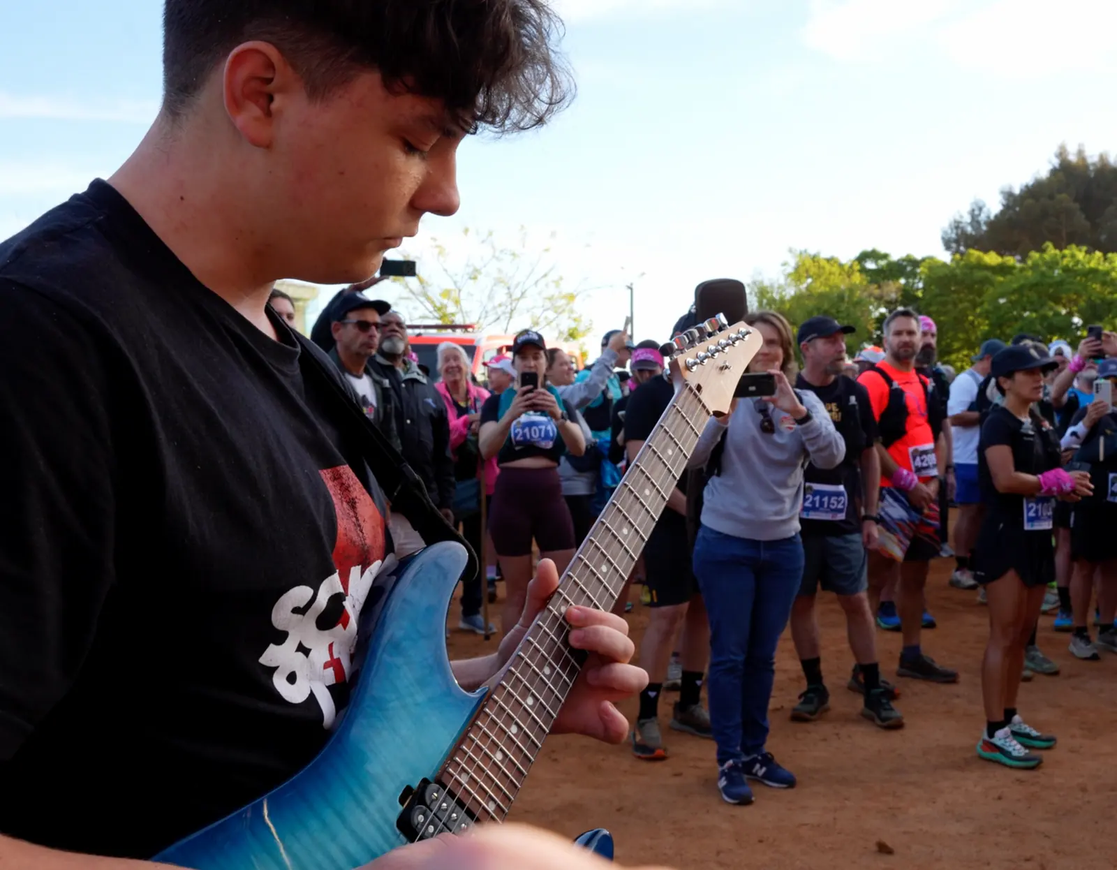 School of Rock guitarist playing the anthem at the start line